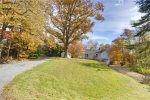 Large front yard with mature hardwood trees